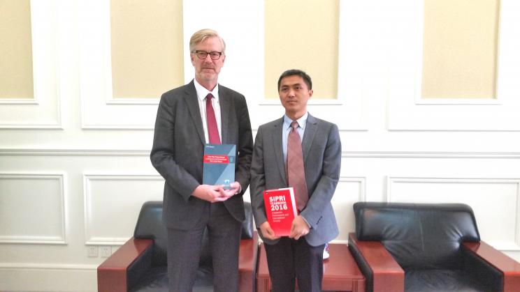 Dr Xu Longdi, Associate Research Fellow and expert on cyber security, and SIPRI Director Dan Smith exchange publications at the China Institute of International Studies