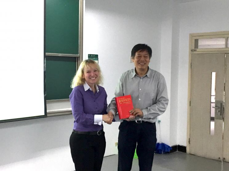 Dr Yu Xiaofeng, Director of the Centre for Non-Traditional Security and Peaceful Development at Zhejiang University, receives the Chinese translation of SIPRI Yearbook 2015 from SIPRI's Dr Lora Saalman