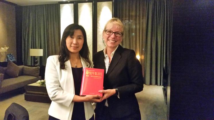 Dr Zhang Huizhi, Associate Dean of the Northeast Asia Studies College of Jilin University, receives the Chinese translation of SIPRI Yearbook 2015 from SIPRI's Dr Lora Saalman