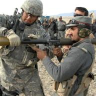 A US Army soldier coaches an Afghan National Police officer. Photo: The U.S. Army/Flickr